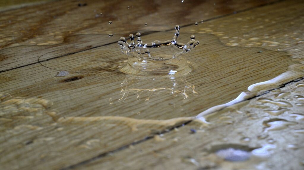 Drops of water falling on a wood floor 