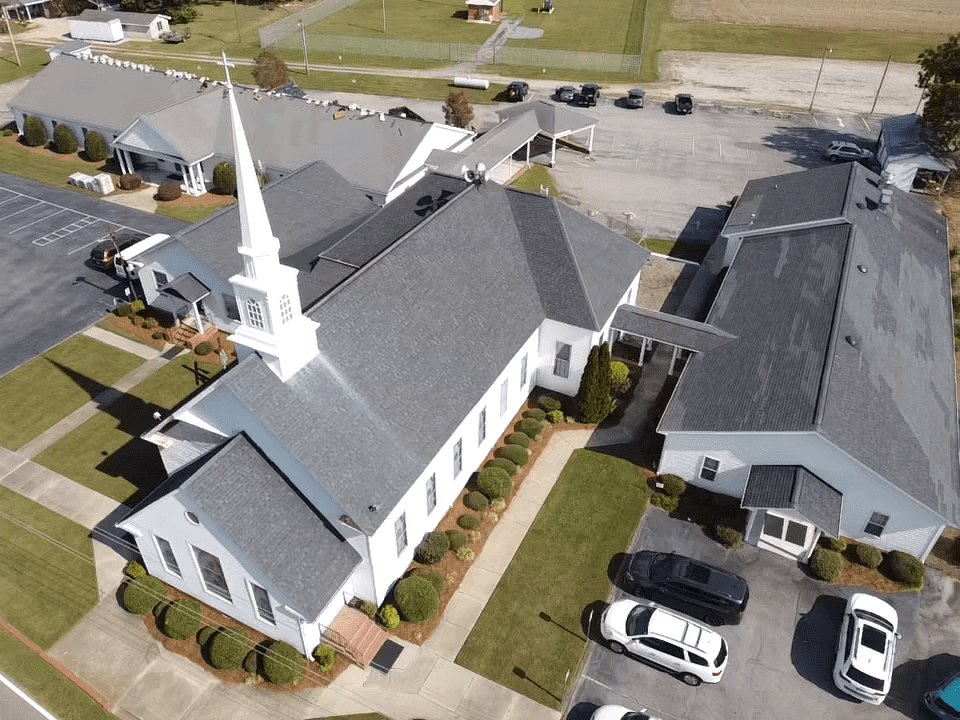 white church with grey roof and a white tower