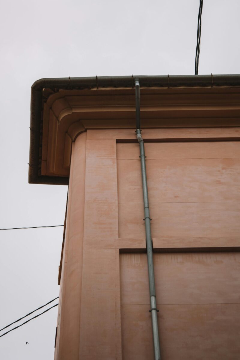 Close-up of residential building corner with gutter in Valencia, Spain.