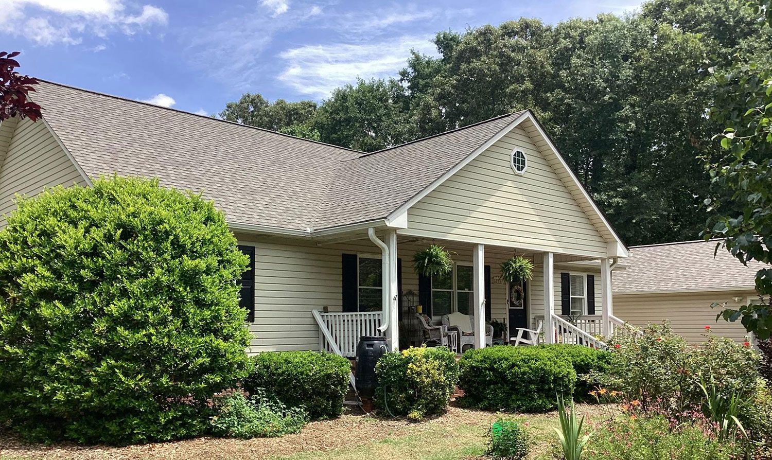 A tidy home with well-maintained gutters, downspouts, and soffits visible under eaves.