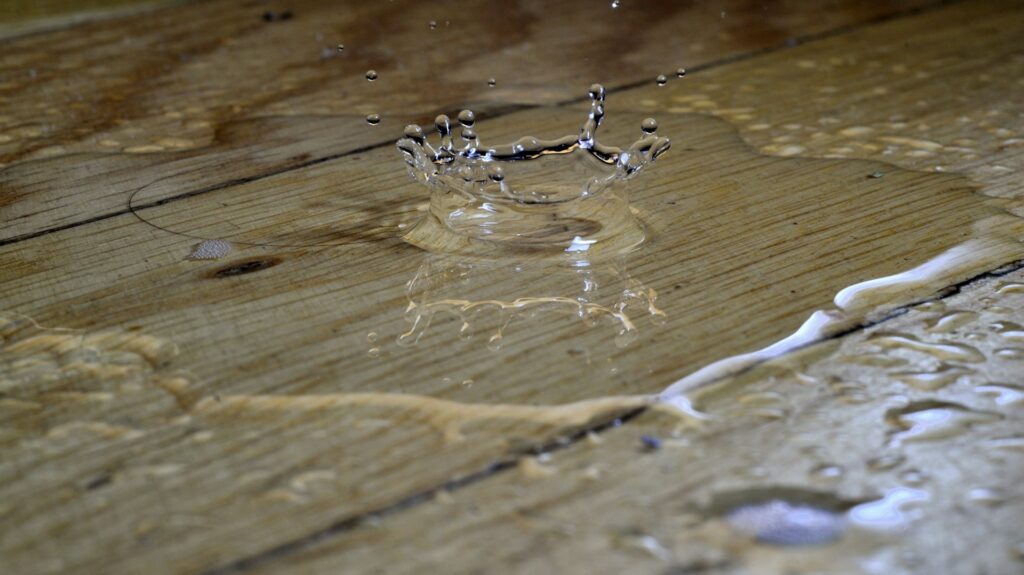 Drops of water falling on a wood floor