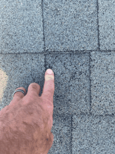 Missing granules on asphalt shingle