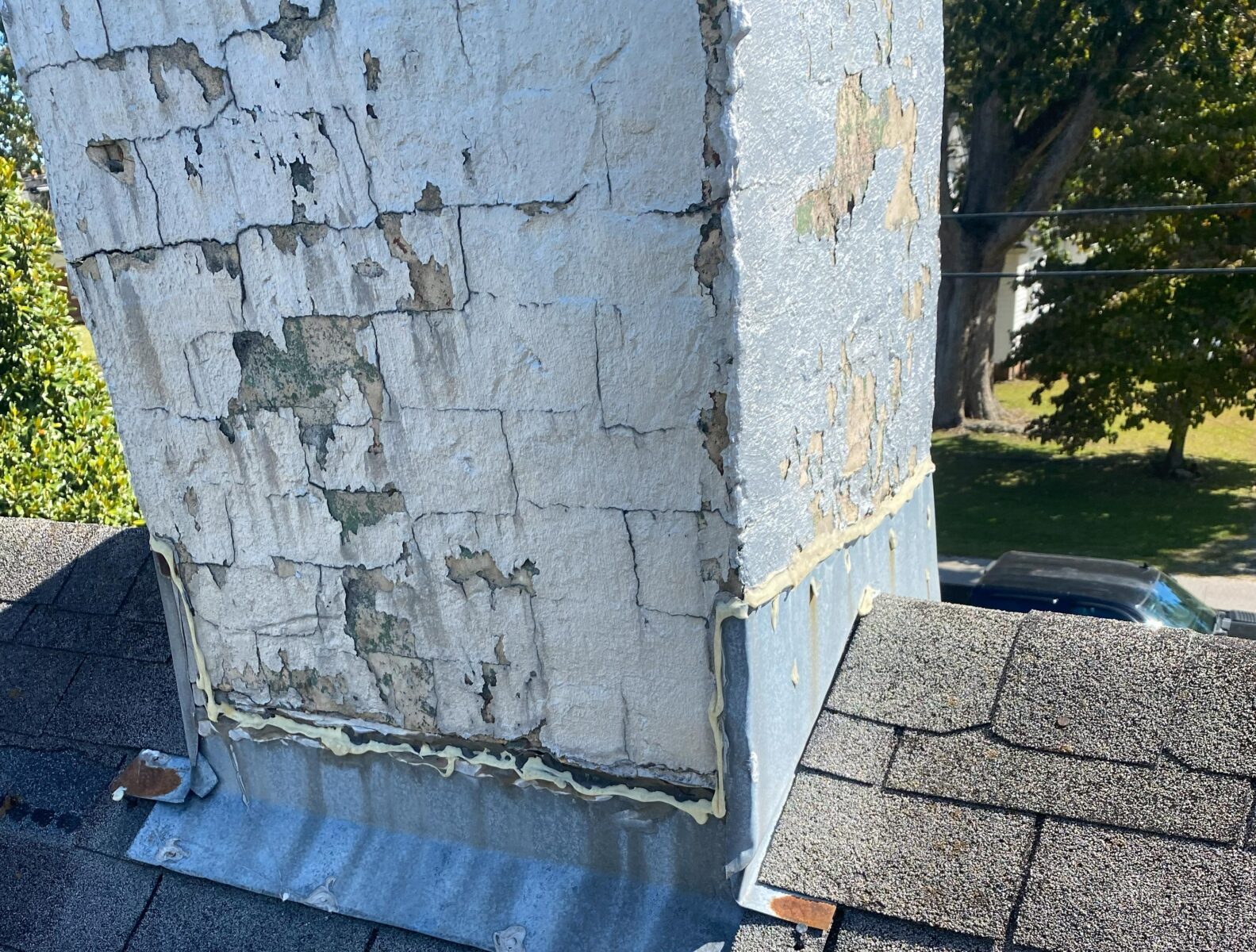 A damaged chimney with old flashing around it