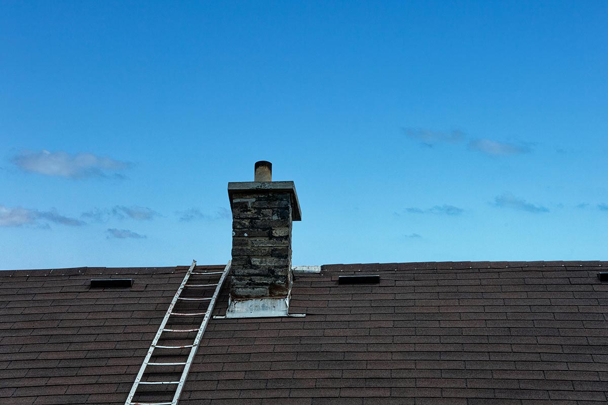 An old asphalt shingles roof with old flashing