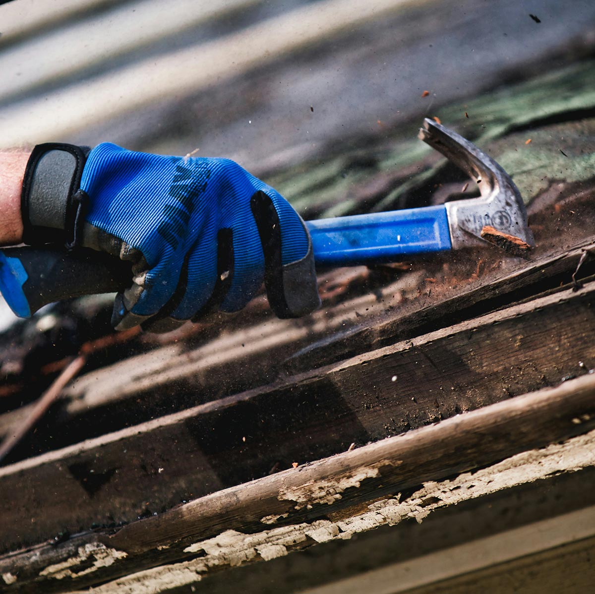 A roofer replacing an old roof
