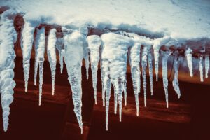 A roof with heavy snow and icicle buildup