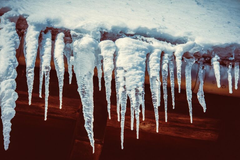 A roof with heavy snow and icicle buildup